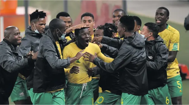  ??  ?? Above: Bongokuhle Hlongwane of South Africa celebrates his goal with teammates during the 2022 Fifa World Cup Qualifier match between South Africa and Ghana at FNB Stadium on 6 September 2021 in Joburg. Below: Hugo Broos, the SA coach, during the 2022 World Cup Qualifier match. Photos: BackpagePi­x/Gallo Images