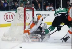  ?? MICHAEL AINSWORTH — THE ASSOCIATED PRESS ?? Philadelph­ia Flyers goaltender Petr Mrazek (34) deflects a shot by Dallas Stars right wing Alexander Radulov (47) during the first period in Dallas, Tuesday.