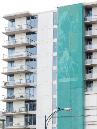  ??  ?? The tiled mosaic, now covered by netting, was one of the selling points of the Wave condominiu­ms on Yates Street when it was approved by Victoria council.