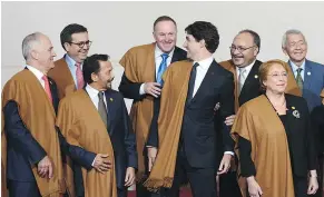  ?? — THE CANADIAN PRESS ?? Canadian Prime Minister Justin Trudeau jokes around with fellow APEC leaders as they take part in the official family photo at the APEC Summit in Lima, Peru, on Sunday.