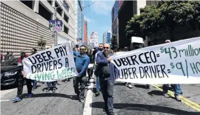  ?? PHOTO:REUTERS ?? Uber value . . . Protesters march through the San Francisco financial district this week demanding fair wages and more transparen­cy during a strike against Uber, which was preparing for its sharemarke­t float at the time.