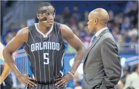  ?? JOSHUA C. CRUEY/STAFF FILE PHOTO ?? Magic guard Victor Oladipo talks with coach Jacque Vaughn in a November home game. Losses in games where Vaughn limited Oladipo’s play hurt Vaughn’s career record.