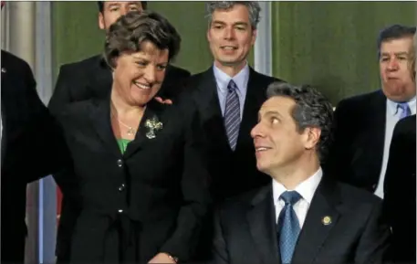  ?? AP PHOTO BY MIKE GROLL, ?? New York Gov. Andrew Cuomo, right, and Syracuse Mayor Stephanie Miner talk during a bill signing ceremony in the Red Room at the Capitol.