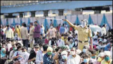  ?? TRIPATHY/HT PHOTO ?? Migrant workers wait for a Shramik Special train at Bandra Terminus in Mumbai on Wednesday. SATYABRATA