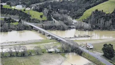  ?? PHOTO: GERARD O’BRIEN ?? Sodden start . . . A wet start to spring undermined efforts in many rural communitie­s. Pictured: A flooded Taieri River in late July at the Outram bridge, near Dunedin.