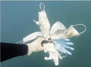  ?? — Operation Clean Sea/ap ?? a photo taken in May showing used plastic gloves and face masks found in the sea off antibes, southern France. Many of the essential products we use now to curb the spread of Covid-19 are hard to recycle.