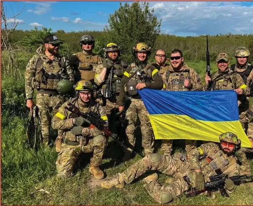  ?? Photograph: Valua Chuk/Facebook ?? Above, Valentyn Ilchuk (far left) after battle in Lukyanivka