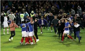  ?? Photograph: James Marsh/Shuttersto­ck ?? Portsmouth’s players celebrate on the pitch after they secured promotion as League One champions by beating Barnsley at Fratton Park.