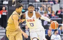  ?? L.E. BASKOW/ASSOCIATED PRESS ?? Team USA’s Paul George (13) drives on Argentina’s Luis Scola during Friday’s exhibition in Las Vegas, Nev.