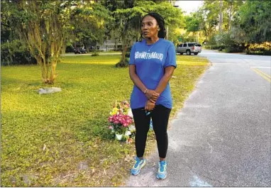  ?? Sarah Blake Morgan Associated Press ?? WANDA COOPER-JONES stands where her son Ahmaud Arbery was killed in a Brunswick, Ga., neighborho­od.