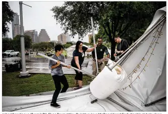  ?? TAMIR KALIFA / AMERICAN-STATESMAN ?? Johnathan Kaaua (from left), Elyse Barmettler, Quinttrevi­ous McDonald and Cody Knoblock help clean up a booth blown over Sunday morning at the Art City Austin art fair at the Palmer Events Center. Despite storm damage to artwork and multiple booths,...