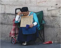  ?? (Marc Israel Sellem/The Jerusalem Post) ?? A POOR woman appeals for help in Jerusalem. The issue of inequality in social services is addressed in a report scheduled to be released today.