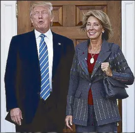  ?? REUTERS ?? US president-elect Donald Trump poses with bilionaire Betsy DeVos after their meeting in Bedminster, New Jersey Tuesday.