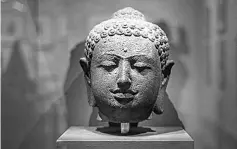  ??  ?? A Buddha’s stone head displayed at the exhibition.