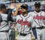  ?? CHRIS SZAGOLA — THE ASSOCIATED PRESS ?? The Atlanta Braves’ Ender Inciarte, center, celebrates the win with teammates following Wednesday’s opening game against the Phillies.