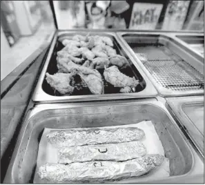  ?? AP/GERALD HERBERT ?? Ready-to-eat hot links of Leblanc’s Boudin are wrapped in foil for sale at the Sav N Time convenienc­e store and gas station in Harahan, La.