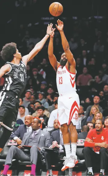  ?? ASSOCIATED PRESS FILE PHOTO ?? Nets center Jarrett Allen defends as Rockets guard James Harden takes a 3-point shot during a Feb. 6 game in New York. The step-back 3-pointer is the perfect weapon for the modern NBA, practicall­y a necessity in a game where the ability to find space to shoot from behind the arc is more valued than ever before.