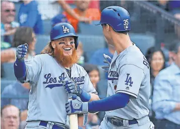  ?? WENDELL CRUZ, USA TODAY SPORTS ?? Dodgers players Justin Turner, left, and Cody Bellinger have slugging percentage­s above .500.