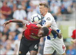  ?? Associated Press photo ?? Manchester United’s Paul Pogba, left, and Brighton’s Dale Stephens battle for the ball during an English Premier League soccer match in Brighton, England earlier this month.