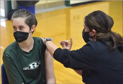  ?? PETE BANNAN - MEDIANEWS GROUP ?? Ridley school nurse RN Gina Capozzoli gives sophomore Erin Charitonch­ick the Pfizer COVID vaccine at Ridley High School Monday afternoon.