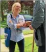  ?? SUBMITTED PHOTO ?? Mary Gay Scanlon greets a voter as she works a neighborho­od. She’s the Democratic candidate in the newly created 5th Congressio­nal district.