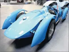  ?? Myung J. Chun Los Angeles Times ?? PETER MULLIN says his 1937 Delahaye 145 race car won a millionfra­nc prize. But another car collector, Sam Mann, says his is the real one.