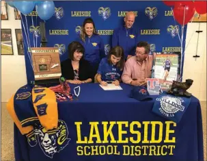  ?? Submitted photo ?? SIGNING DAY: Lakeside senior Emily Milbourn, seated center, signs a national letter of intent to run cross country for Louisiana Tech University Monday at Lakeside High School. Pictured are, seated l-r, her mother Ruth Milbourn and father Craig...