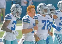  ?? STEPHEN BRASHEAR/ASSOCIATED PRESS FILE PHOTO ?? Cowboys quarterbac­k Andy Dalton, second from left, threw two intercepti­ons in a 38-10 loss to Arizona on Monday night in his first start since starter Dak Prescott was injured.
NFL