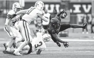  ?? Charlie Blalock/ Contributo­r/ ?? Incarnate Word running back Marcus Cooper (5) dives for yardage during the third quarter of Saturday’s playoff game against Furman at Tom Benson Stadium.