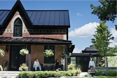  ?? MIKE CHAJECKI ?? Jim Sleeth and Dana Sinclair, with daughters Morgan and Hunter, enjoy the big front porch of their 1867 farmhouse.