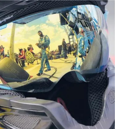  ?? JOHN LOCHER/AP ?? Pit crew members for driver Kyle Larson are reflected in a helmet during a NASCAR Cup Series on March 6 in Las Vegas.