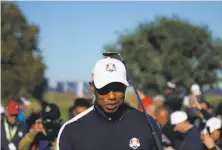  ?? Lionel Bonaventur­e / AFP/Getty Images ?? Tiger Woods walks the course during a practice session before the 42nd Ryder Cup at Le Golf National Course in France.