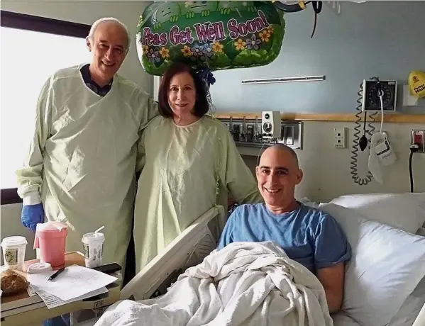  ??  ?? Dr Eaton, who survived leukaemia, poses for a photo with his parents following his bone marrow transplant. He says he ran up medical bills of US$500,000 (RM2.11mil) when he participat­ed in a clinical trial of CAR-T cells in 2013, despite receiving the...