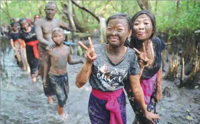  ?? SONNY TUMBELAKA AGENCE FRANCE-PRESSE ?? Balinese girls take part in traditiona­l mud baths known as Mebuug-buugan on Indonesia’s resort island of Bali on Sunday. Mebuug-buugan is held a day after Nyepi, or the Day of Silence, which is aimed at neutralizi­ng bad traits.