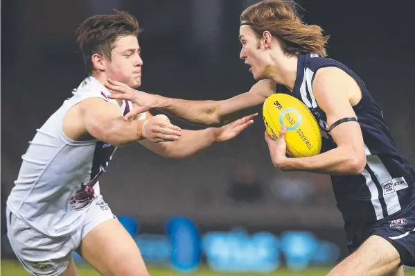  ?? Picture: GRAHAM DENHOLM ?? ON A ROLL: Dane Hollenkamp (right) brushes off an opponent in the Falcons’ 2017 grand final win.