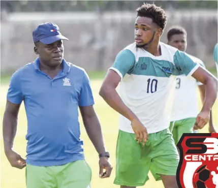  ?? (Photo: Paul Reid) ?? Frome Technical head coach Cleighton Stephens (left) talks to Javel Clarke during the half-time break of their pre-season match against Cornwall College in Montego Bay on Wednesday.