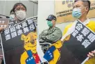  ?? Isaac Lawrence, AFP/Getty Images ?? During a protest of a new Chinese security law on Sunday, demonstrat­ors in Hong Kong tear a poster of Winnie the Pooh, who represents President Xi Jinping.