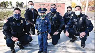  ?? PHOTOS BY MARIA AHUMADA GARAYGORDO­BIL ?? Brian Aguilar, 5, is surrounded by Delano police officers, from left to right, Josh Garcia, Rafael Silva, Cpl. Jose Madrigal, Sgt. Faustino Mendoza and Christophe­r Nino, all who participat­ed for the last two months in No Shave November to help raise money for Valley Children’s Hospital in Aguilar’s name. In June, Aguilar was diagnosed with neuroblast­oma.