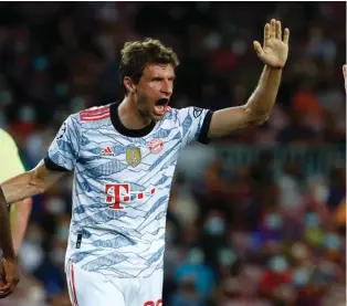  ??  ?? Muller celebrates with Sane’ after putting Bayern ahead against Barcelona