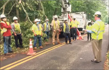  ?? Eversource / Contribute­d photo ?? James Judge, right, visited a group of line workers during the post-Isaias storm recovery in Connecticu­t. Judge is chairman and CEO of Eversource, where he has been criticized for failing to be the public face of the company during an extended power failure that saw 60 percent of customers lose service.