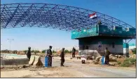  ?? AP/SANA ?? Syrian troops stand guard Saturday at the Naseeb crossing on the country’s border with Jordan.