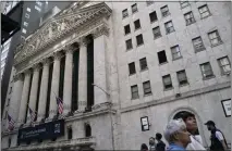  ?? JOHN MINCHILLO – THE ASSOCIATED PRESS ?? Pedestrian­s pass the New York Stock Exchange in May in the Manhattan borough of New York. Stocks on Thursday continued a dismal streak that brought on a bear market last month.