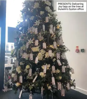 ?? ?? PRESENTS: Delivering Joy tags on the tree at Dunelm’s Syston office