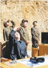  ?? KRT via Associated Press ?? This image from North Korea state TV reportedly shows Kim Jung Un watching the launch of an ICBM.