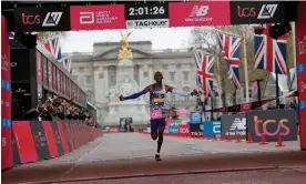  ?? ?? Kenya’s Kelvin Kiptum crosses the finish line to win the elite men’s race, 16 seconds off world-record pace. Photograph: Tom Jenkins/The Guardian