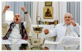  ??  ?? UNHOLY ROW:
Pryce and Hopkins in The Two Popes, co-written by Cottrell-Boyce, below
