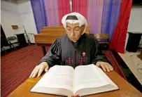  ?? AFP ?? Father Emmanuel Benjamin Jacob Gharib reads from the Bible at the National Evangelica­l Church in Kuwait City. —