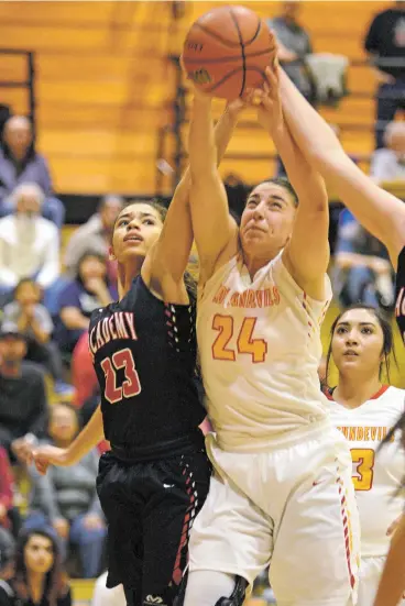  ?? LUKE E. MONTAVON/FOR THE NEW MEXICAN ?? Lady Sundevils senior forward Alexis Lovato, right, shoots against heavy defensive pressure from Albuquerqu­e Academy’s Krystal Brown on Saturday during the District 2-5A girls championsh­ip at Española Valley High School. The Lady Sundevils won 46-31.