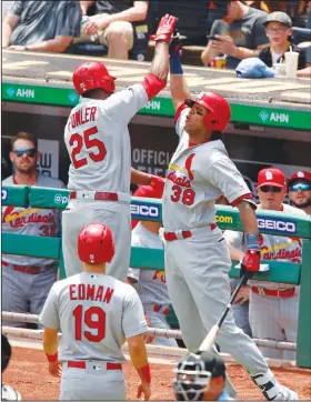  ?? Associated Press ?? Greetings at the dugout: St. Louis Cardinals' Dexter Fowler (25) celebrates with Jose Martinez (38) after hitting a two-run home run off Pittsburgh Pirates starting pitcher Joe Musgrove during the fifth inning of a baseball game in Pittsburgh Thursday.