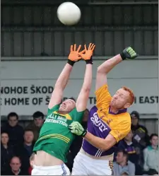  ??  ?? Syl Byrne (Ballyhogue) and Robert Butler (St. Mary’s, Rosslare) stretch every sinew in a bid to gain possession.